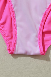 a close up of a pink swimsuit on a wall
