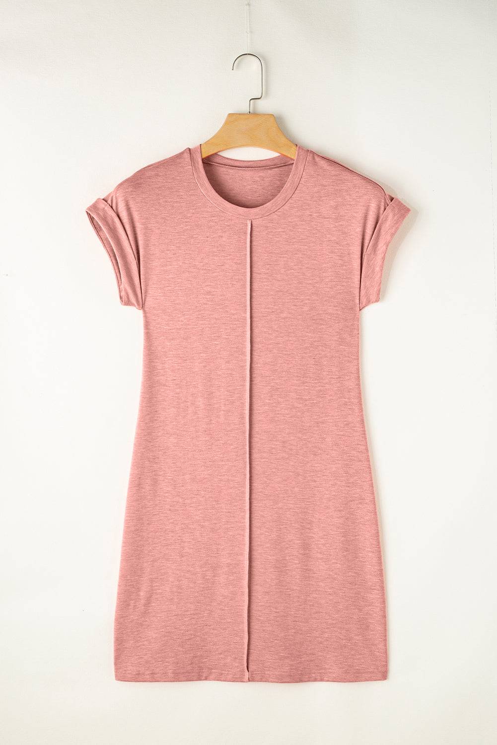 a pink shirt hanging on a wooden hanger