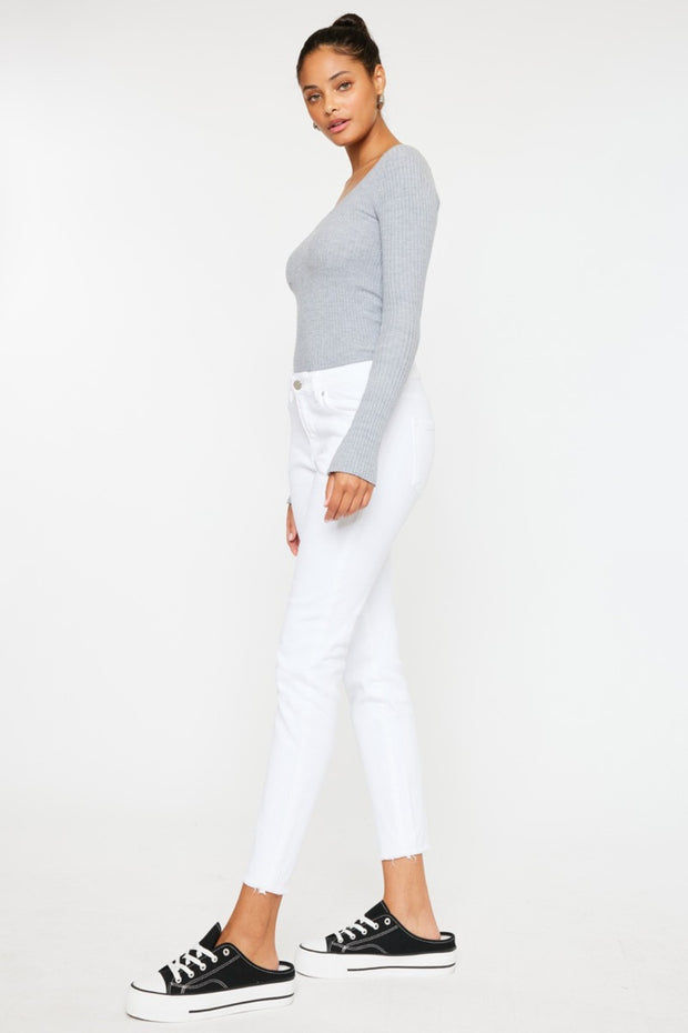 a woman wearing white jeans and a grey sweater