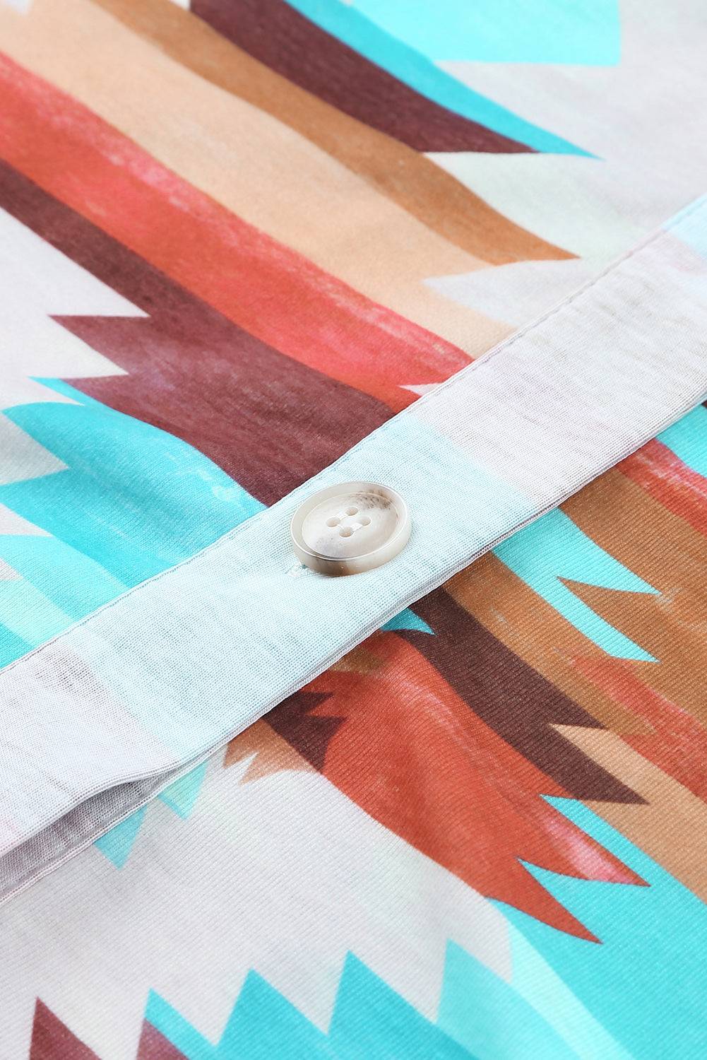 a close up of a shirt with a button