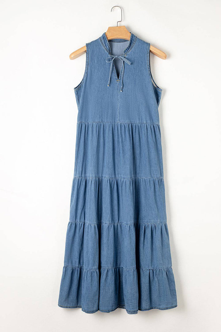a blue dress hanging on a wooden hanger