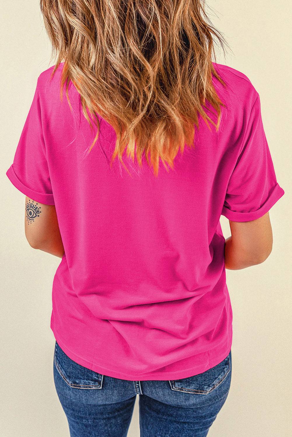 the back of a woman's pink shirt
