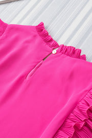 a close up of a pink dress on a bed