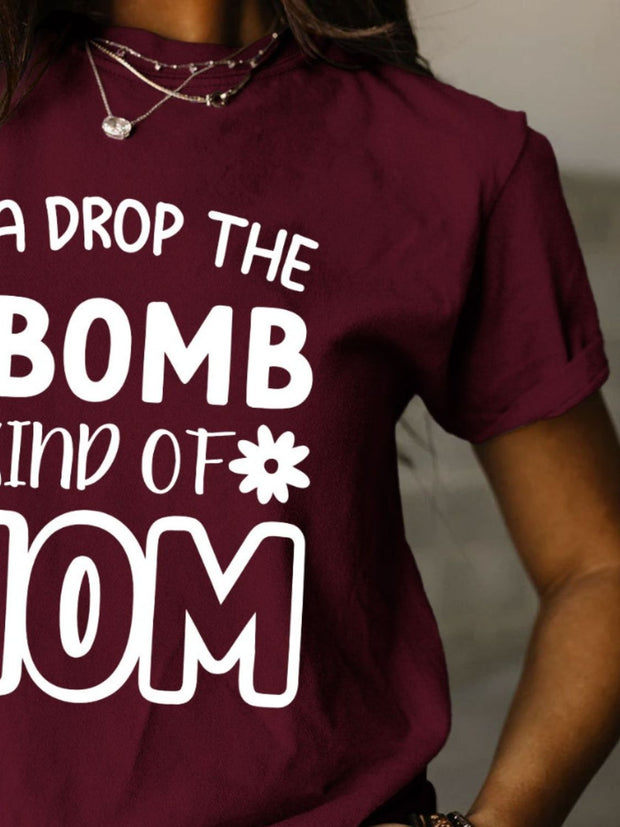 a woman wearing a t - shirt that says i drop the bomb kind of mom