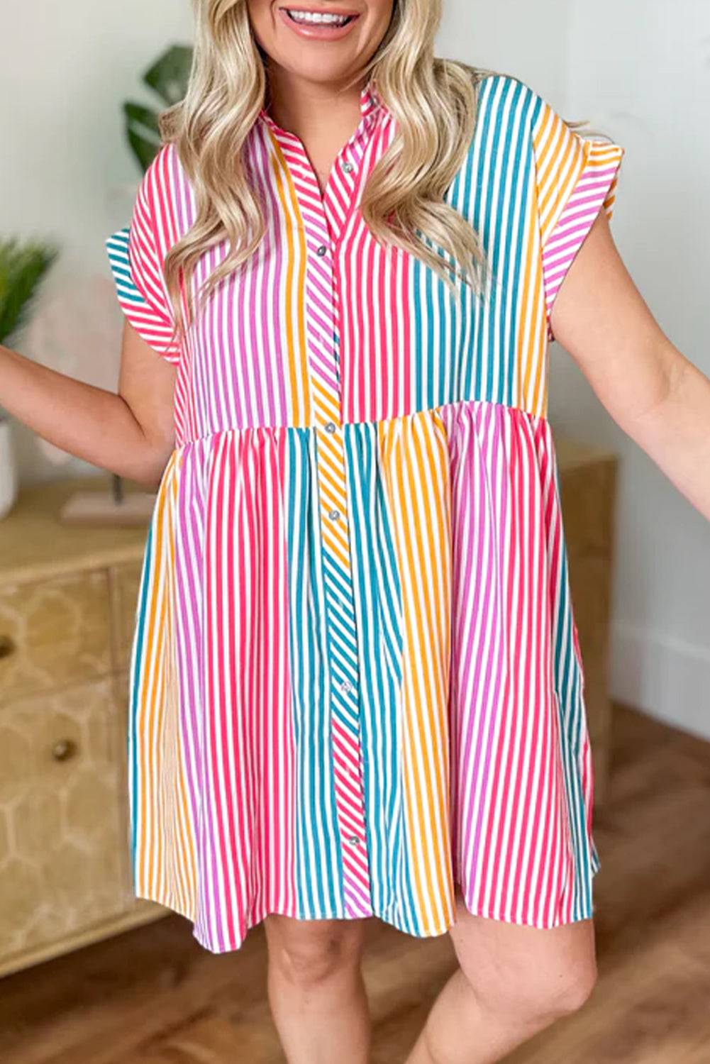 a woman in a colorful dress posing for a picture