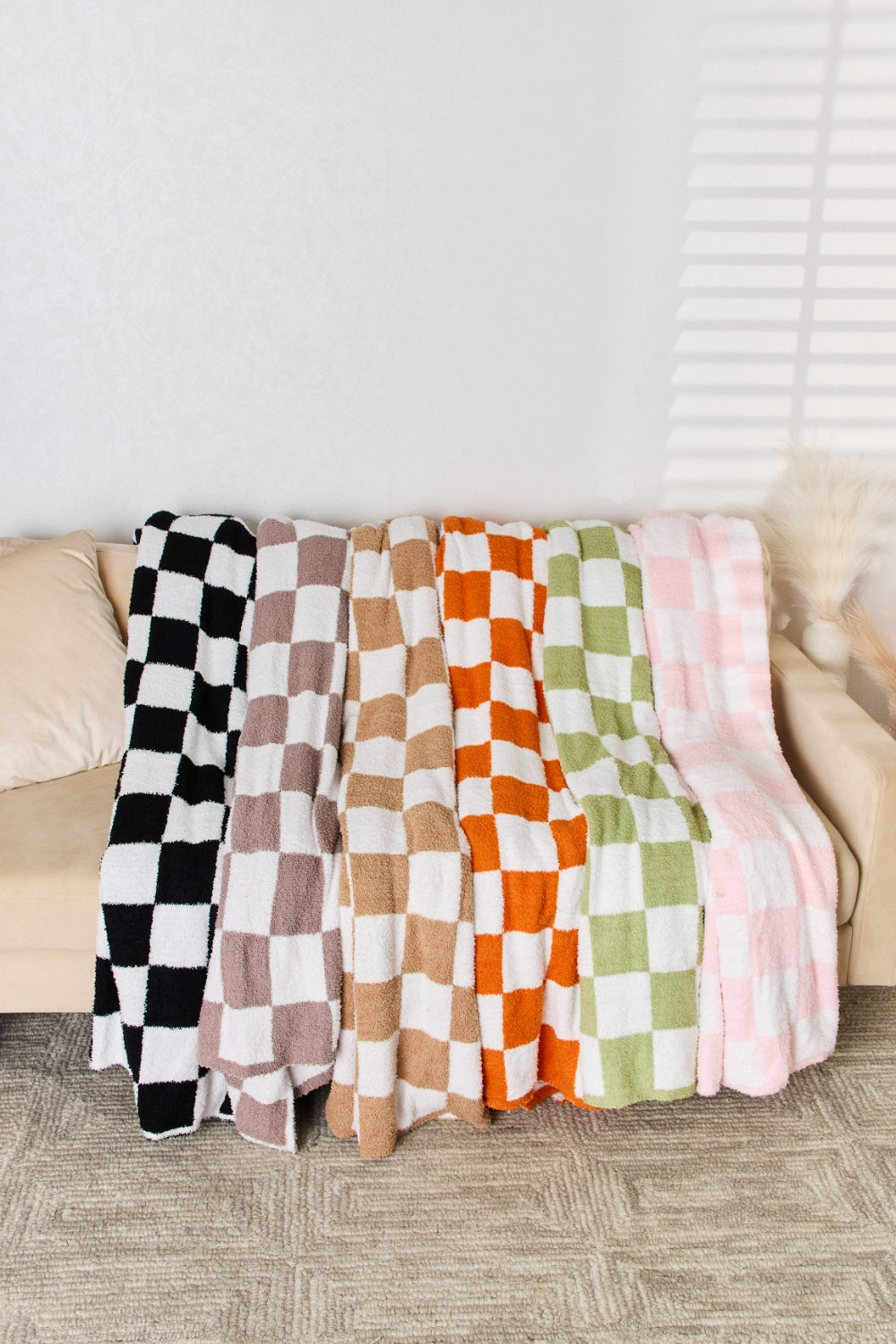 a couch with a checkered blanket on top of it