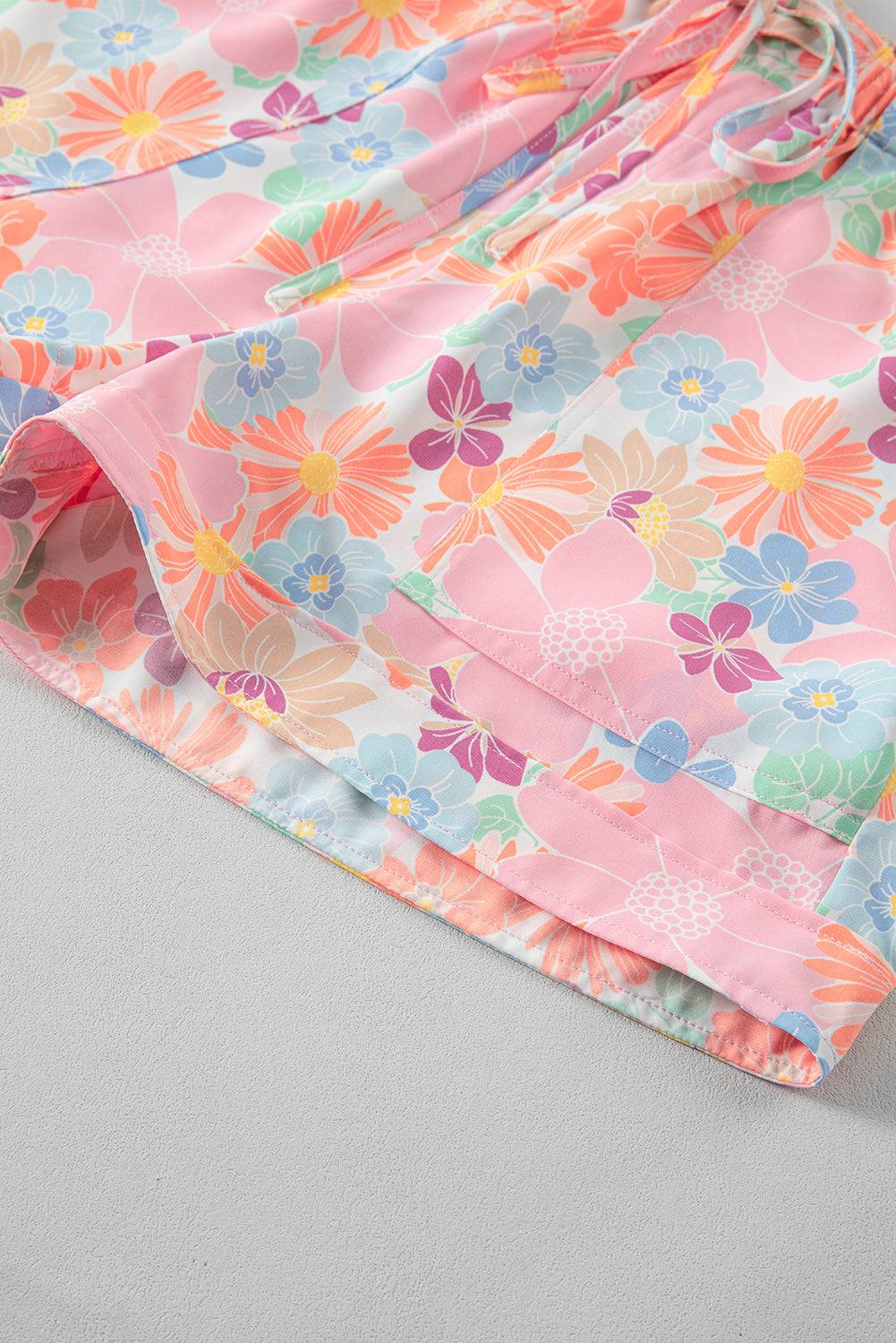 a close up of a flowered skirt on a bed