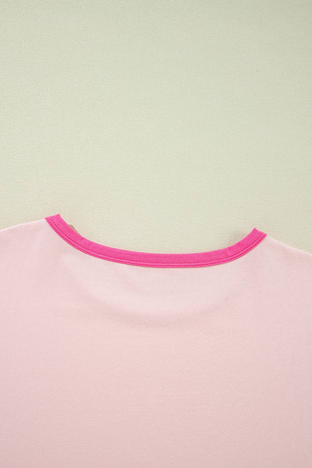 a pink shirt hanging on a wall