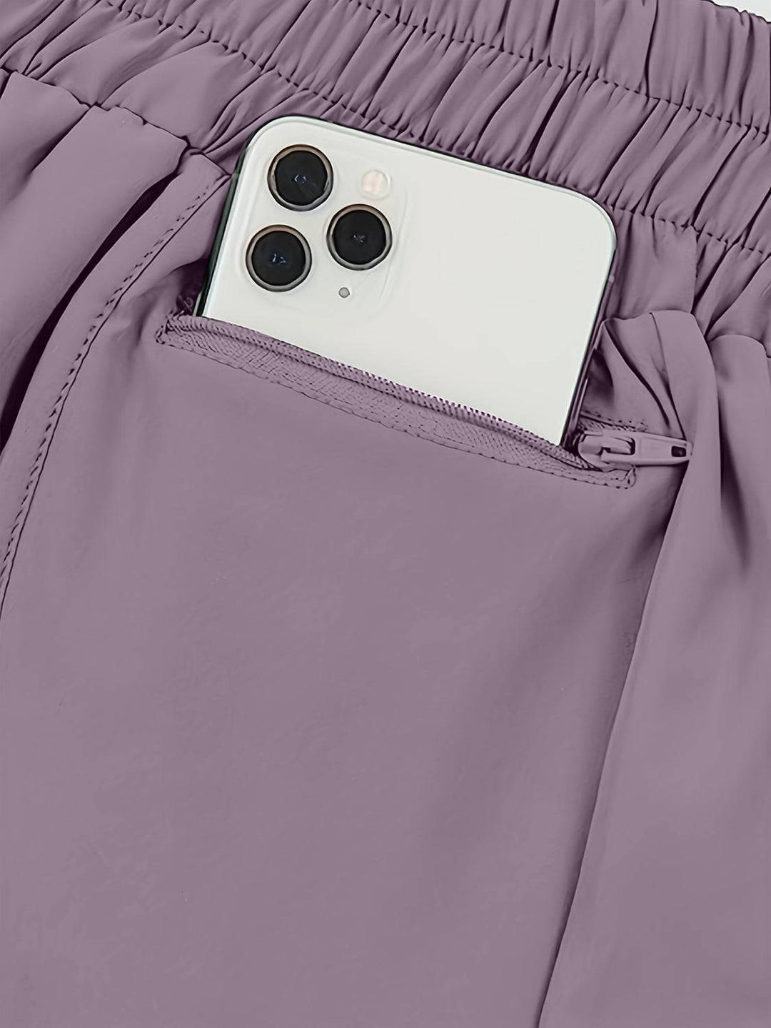 a cell phone sticking out of the pocket of a pair of pants