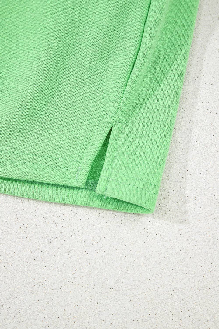Side slit detail of light green French Terry mini skort, adding style and mobility for summer wear from Faith & Co. Boutique.