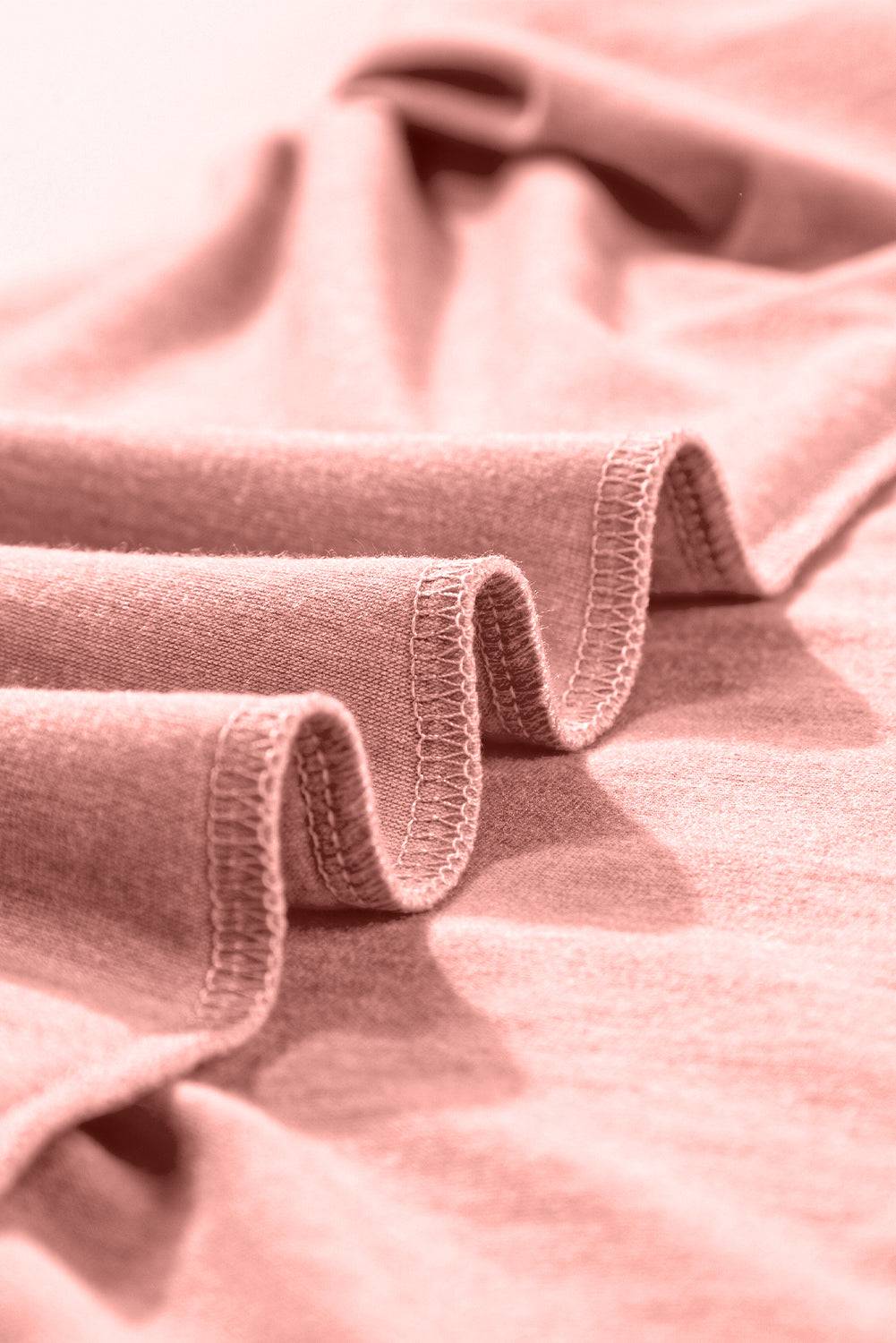 a close up of a bed with a pink comforter