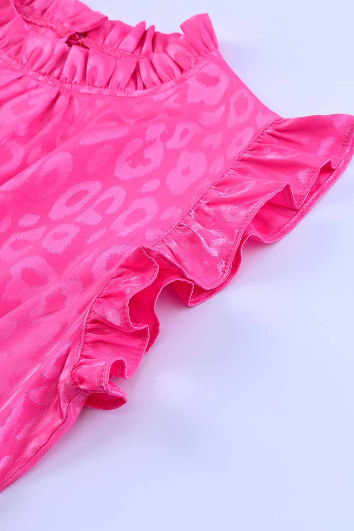 a close up of a pink dress on a white surface