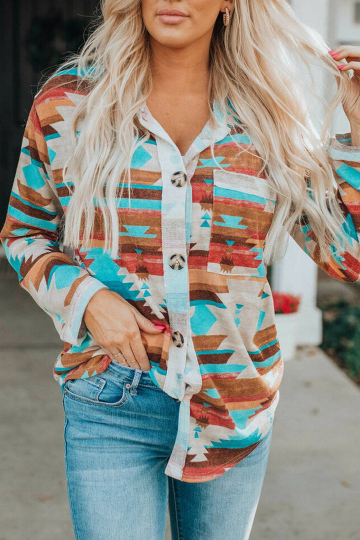 a woman wearing a colorful shirt and jeans