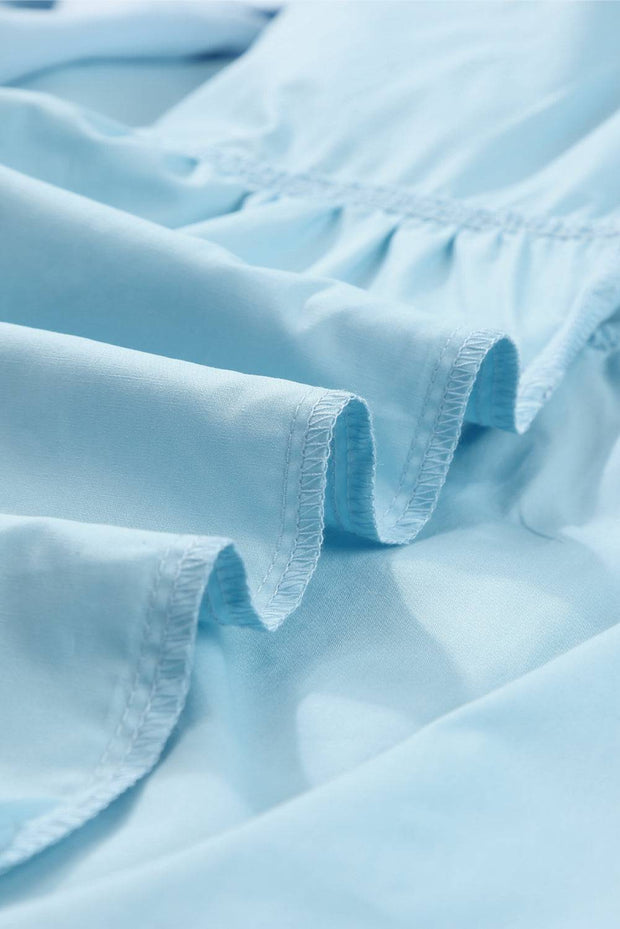 a close up of a blue shirt with ruffles