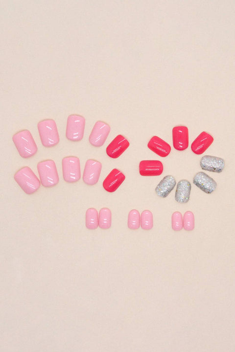 a group of pink and silver pills sitting on top of a table