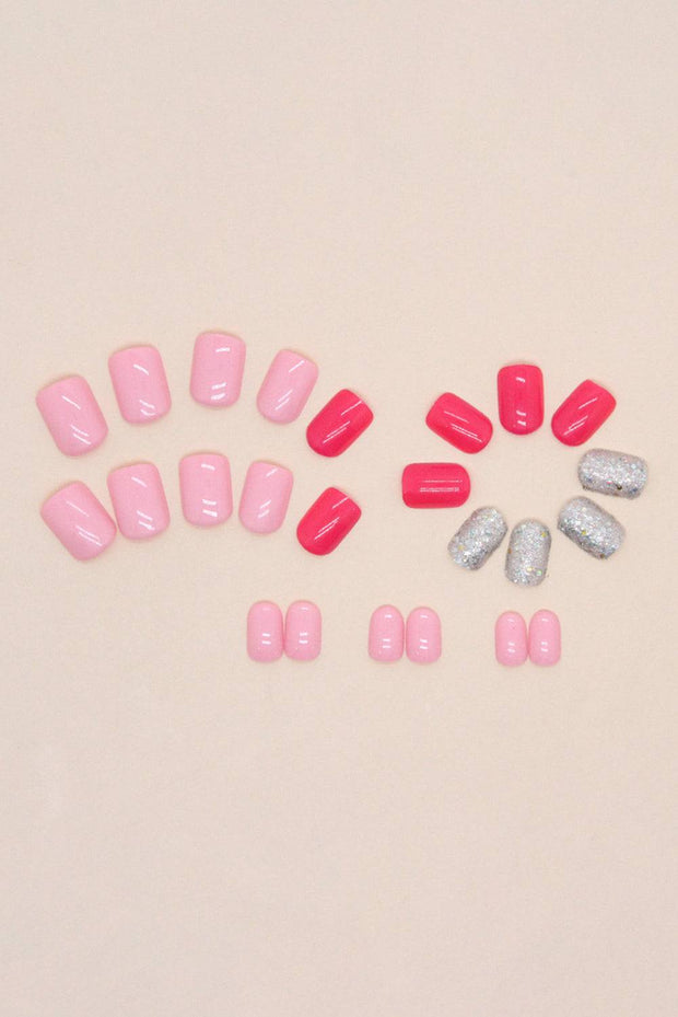 a group of pink and silver pills sitting on top of a table
