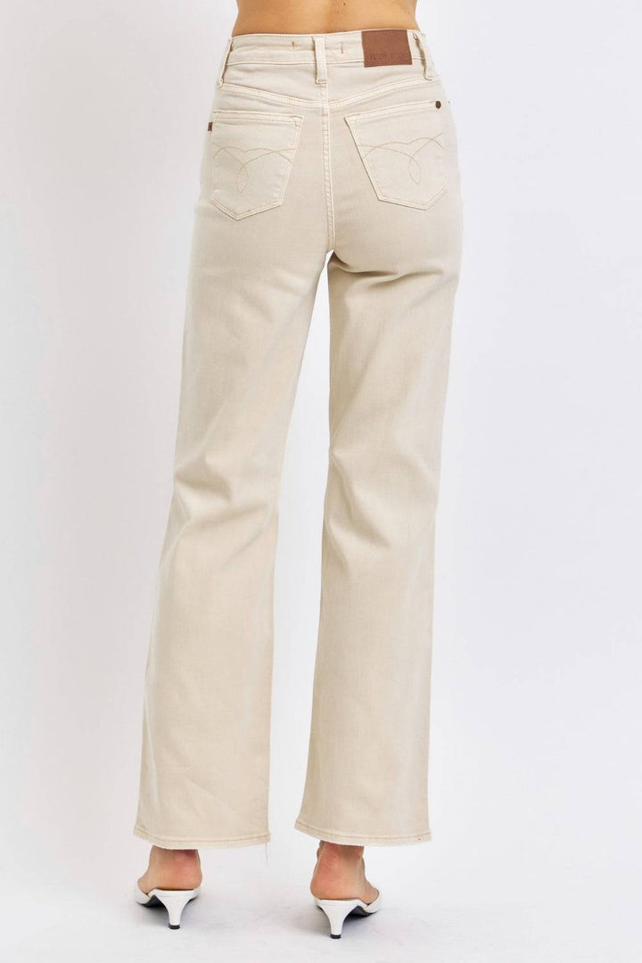 a woman wearing a pair of beige jeans