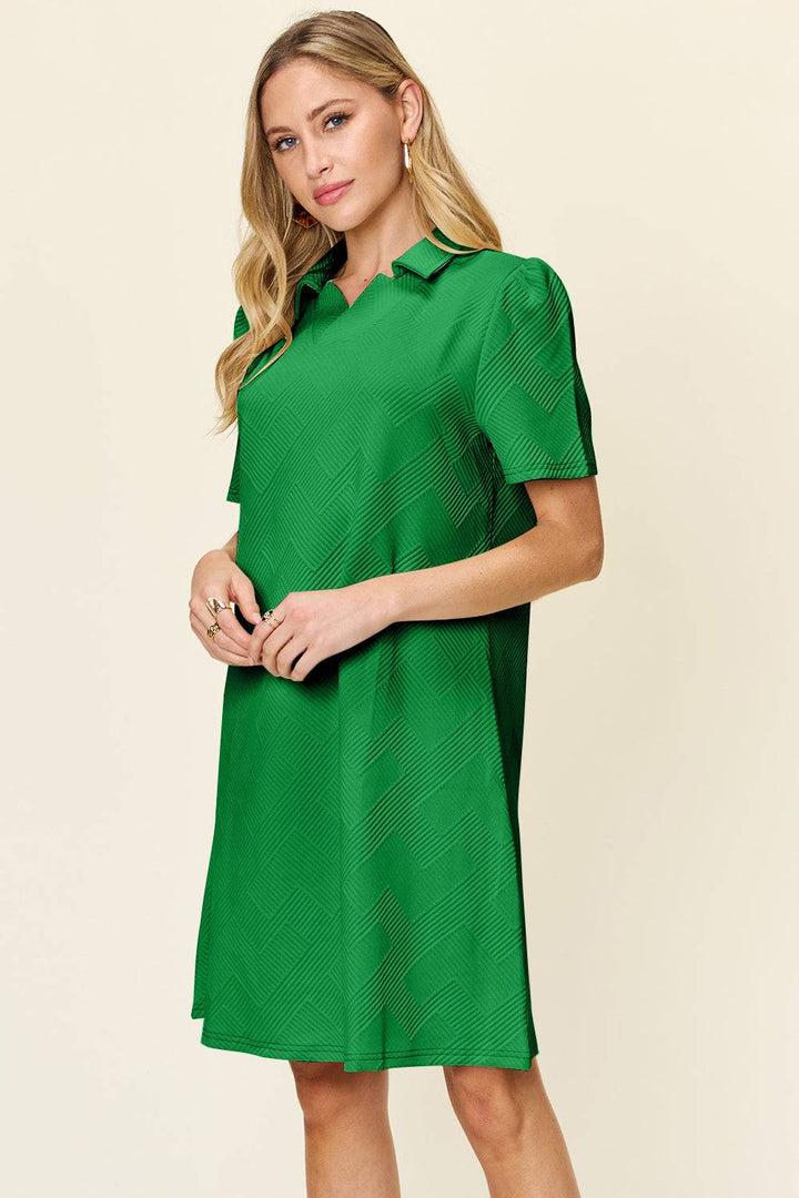 a woman wearing a green dress with short sleeves