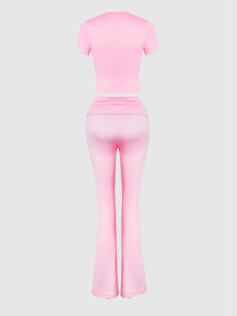 a woman in a pink top and pants
