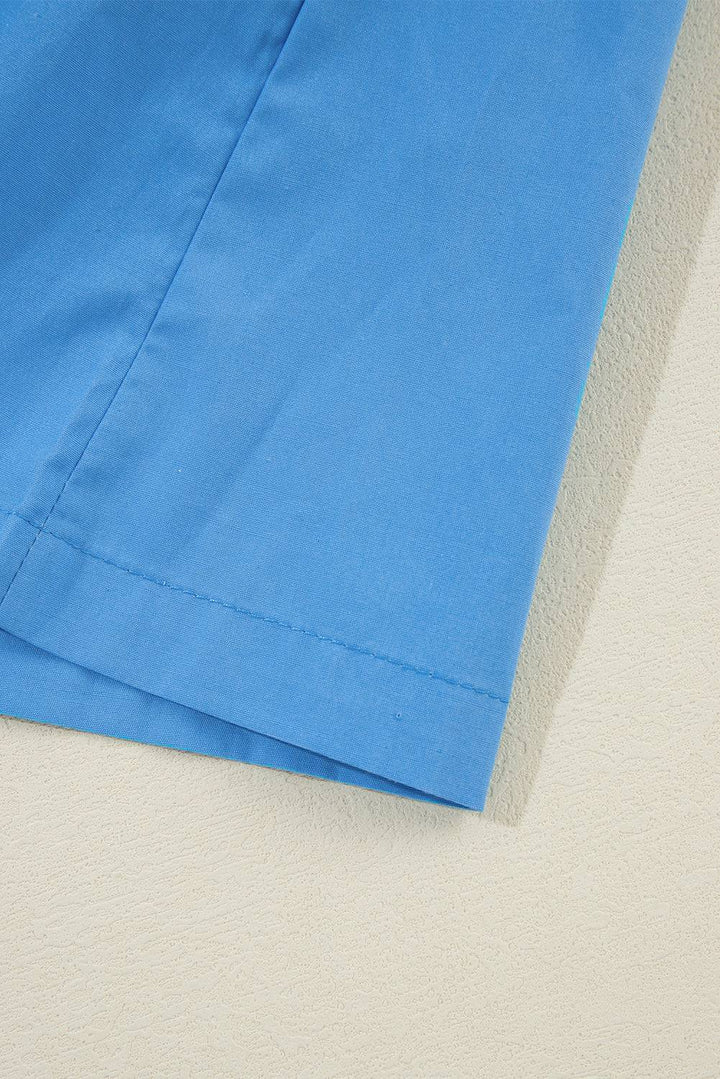 a close up of a blue shirt on a white surface