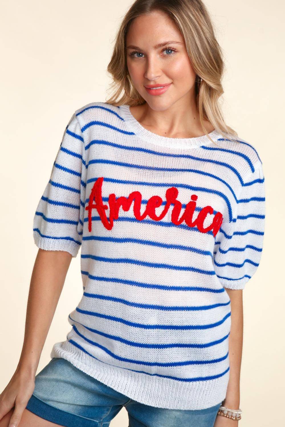 a woman wearing a sweater with the word america on it