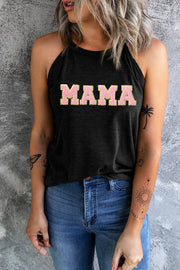 a woman wearing a black tank top with the word mama printed on it