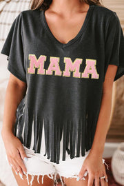 a woman wearing a black shirt with the word mama on it