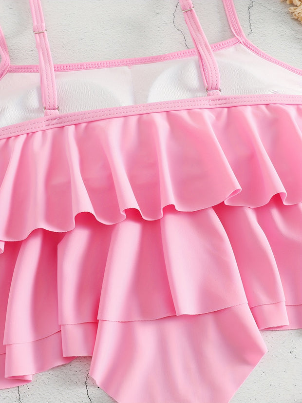 a pink and white swimsuit with ruffles on the bottom