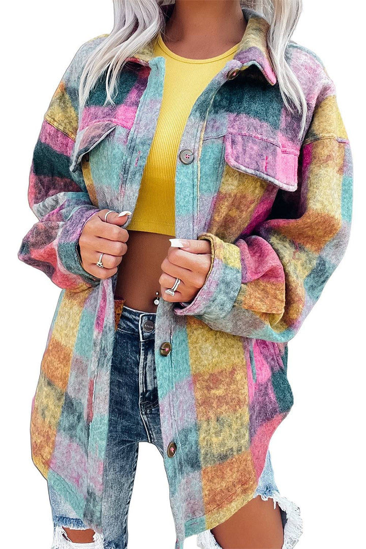 a woman wearing a colorful jacket and ripped jeans