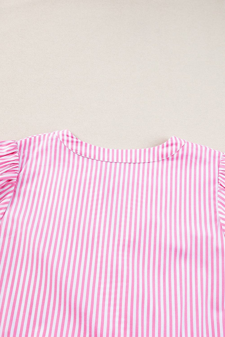 a close up of a pink and white striped shirt