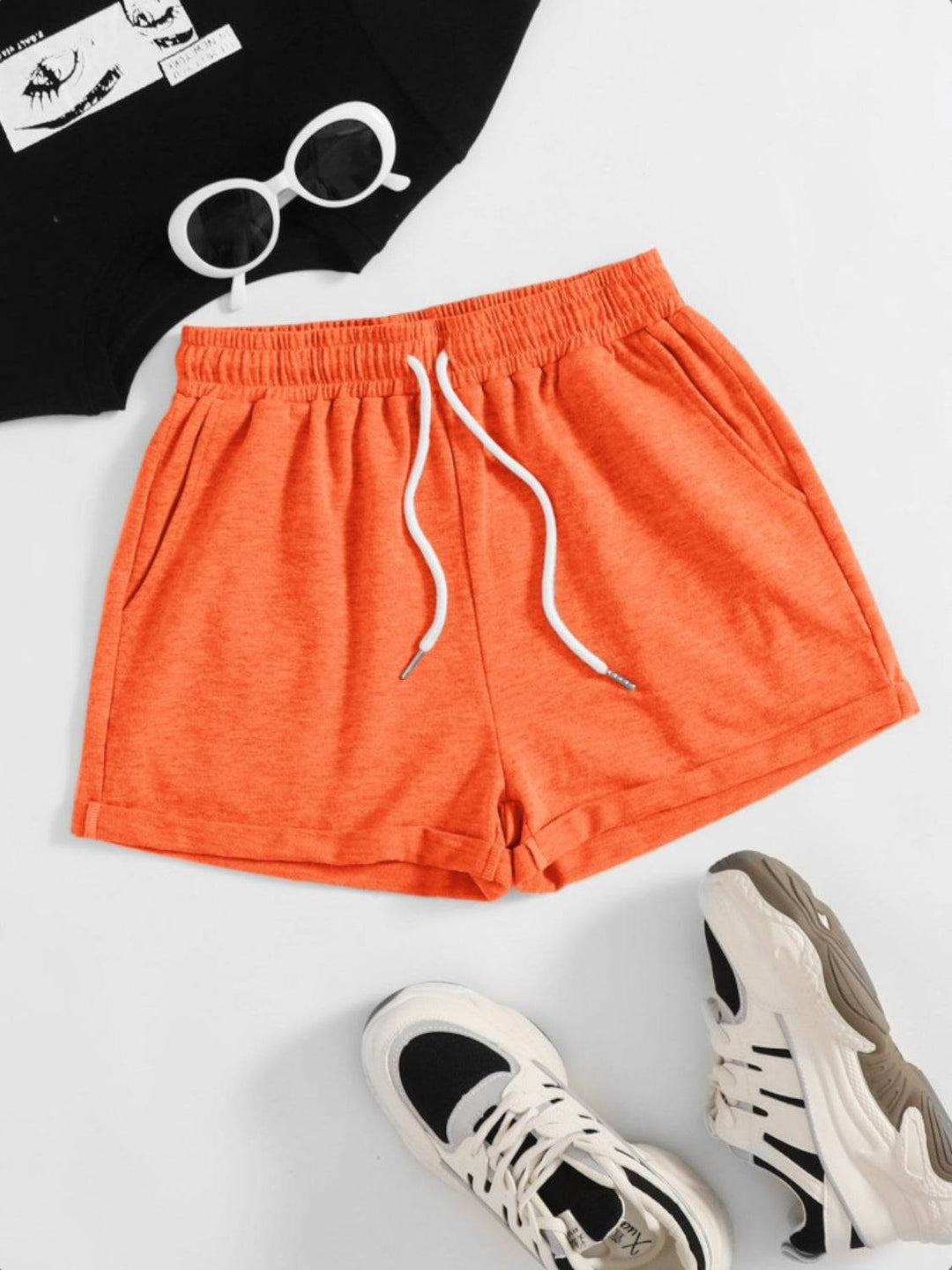 a pair of orange shorts and a black shirt
