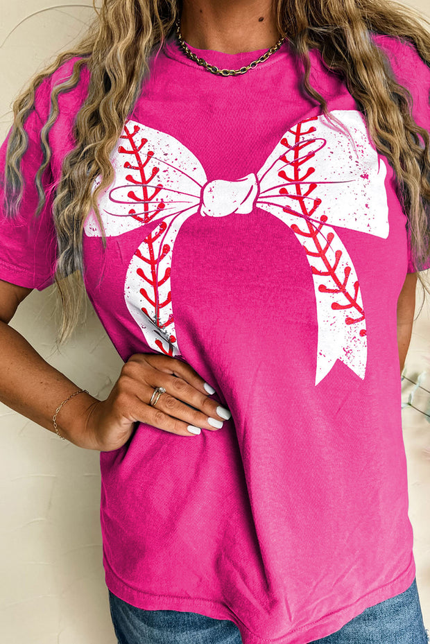 a woman wearing a pink shirt with a baseball design on it