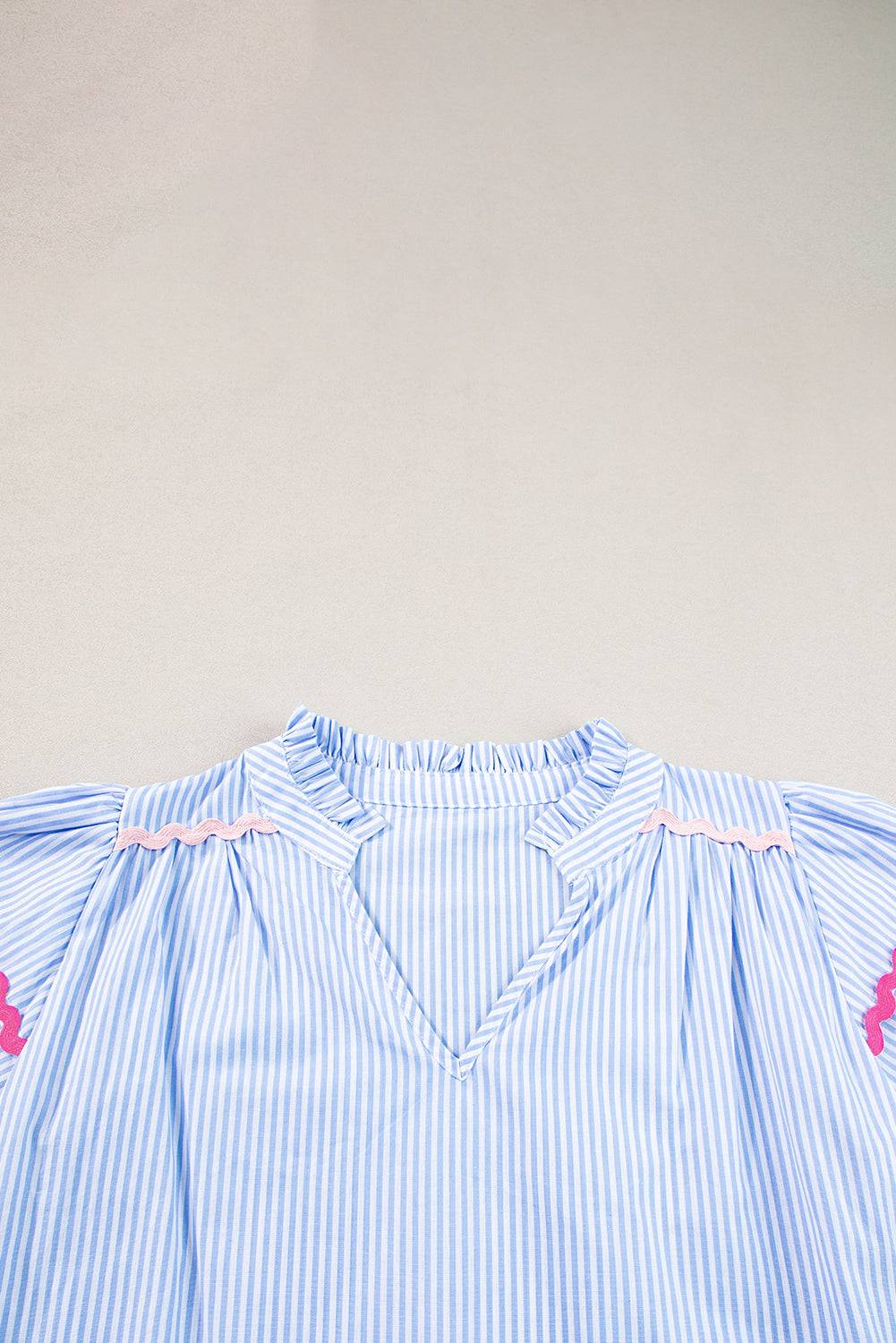 a blue and white striped shirt with a pink heart on it