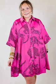 a woman wearing a pink shirt with a leopard print on it