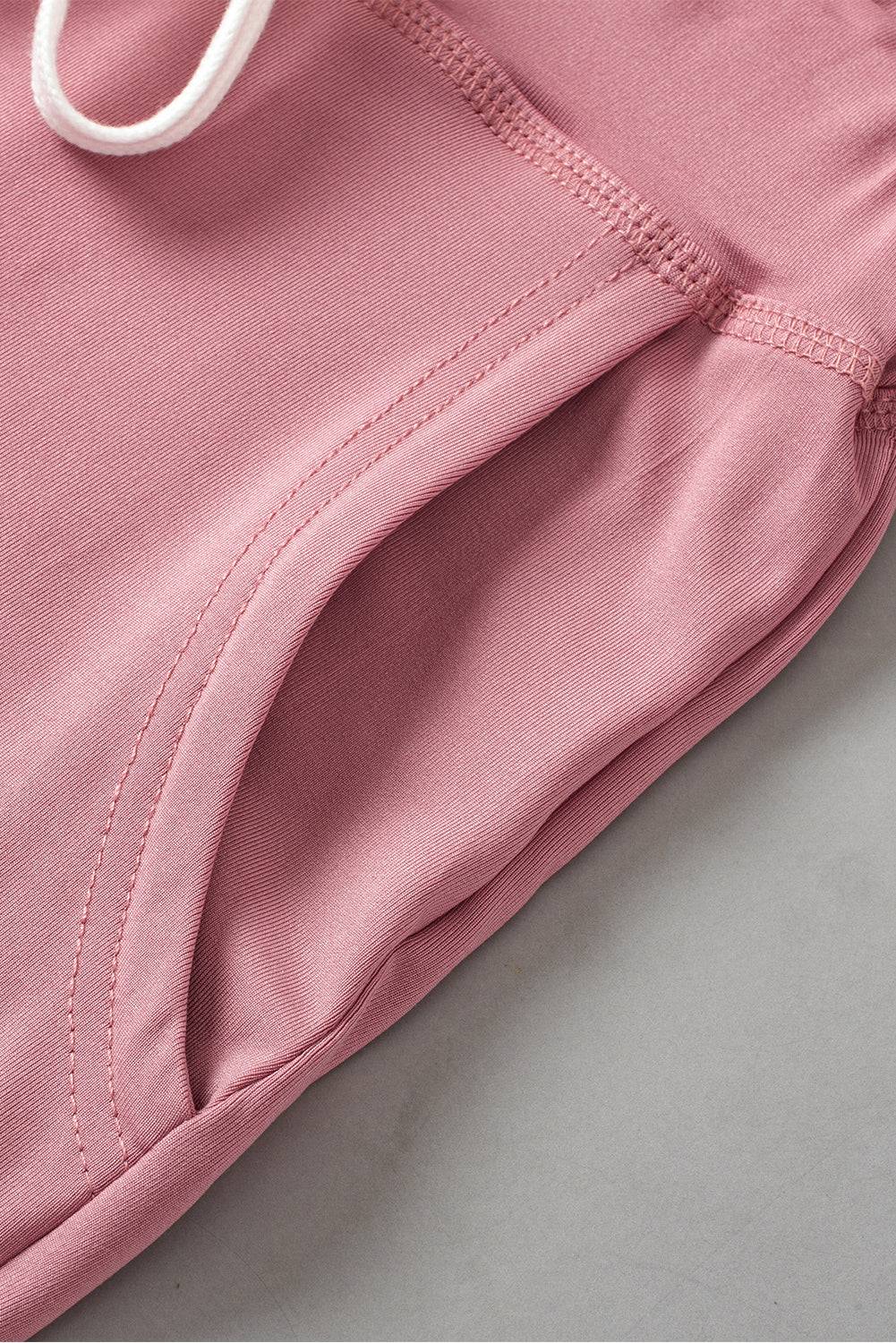 a close up of a pink sweatpants on a white surface