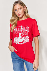 a woman wearing a red nashville t - shirt