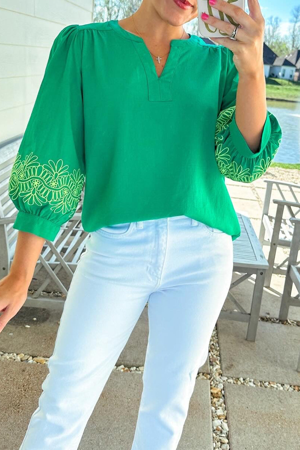 shop Green Contrast Floral Embroidered 3/4 Sleeve Notched V Neck Elegant Blouse at Faith & Co. Boutique, styled with white jeans for a chic spring look.