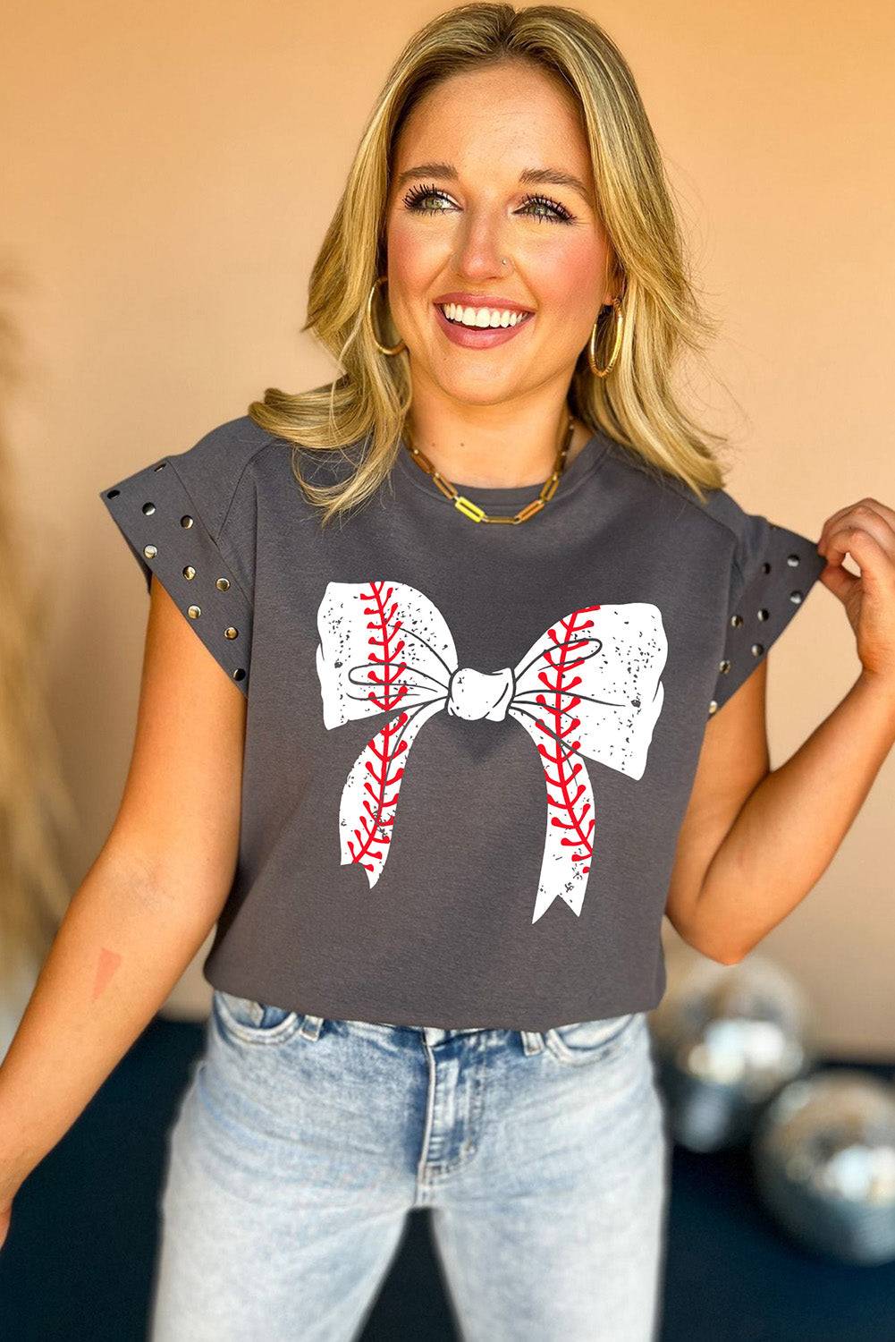 a woman wearing a baseball shirt with a bow