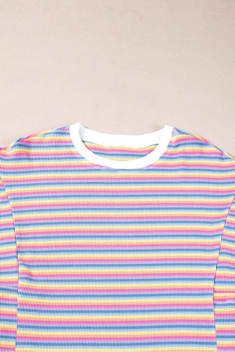 a colorful striped shirt hanging on a wall