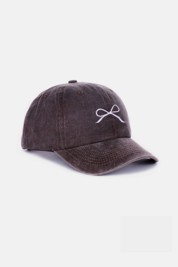 a brown hat with a white bow on it