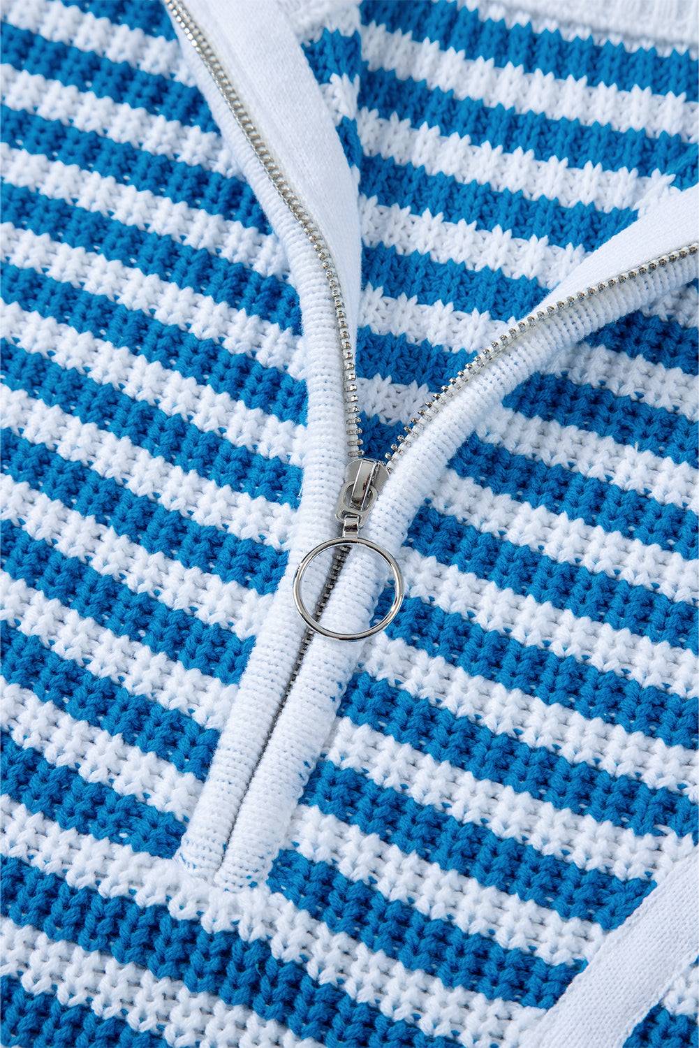 a close up of a zipper on a blue and white sweater