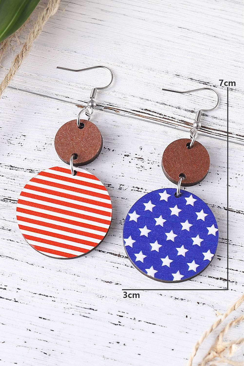 a pair of earrings with an american flag design