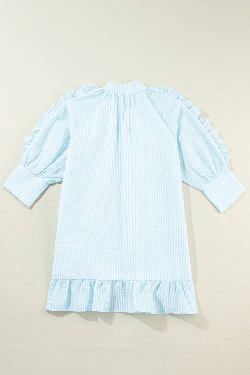 a little girl's blue dress with ruffled sleeves