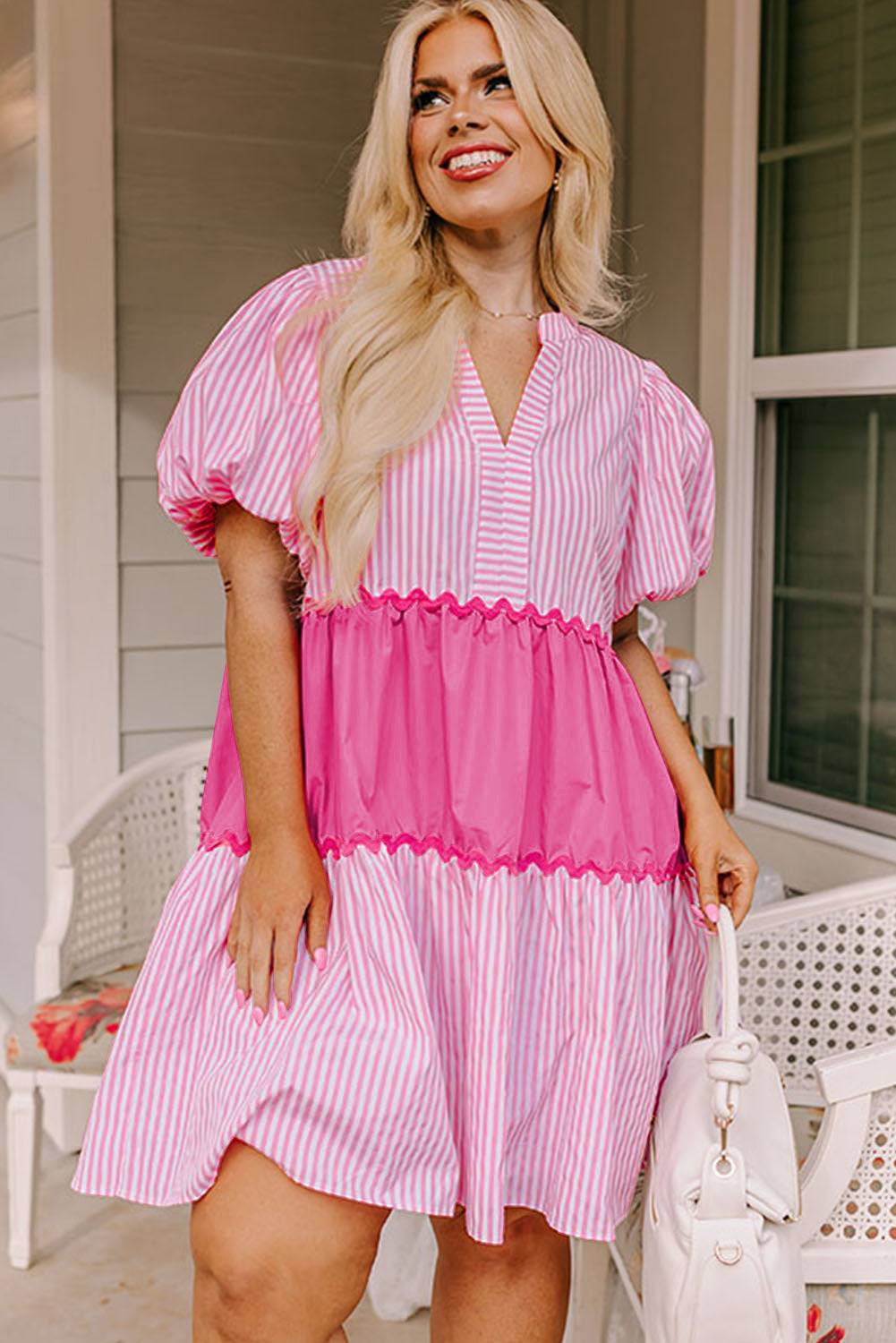 a woman in a pink and white striped dress