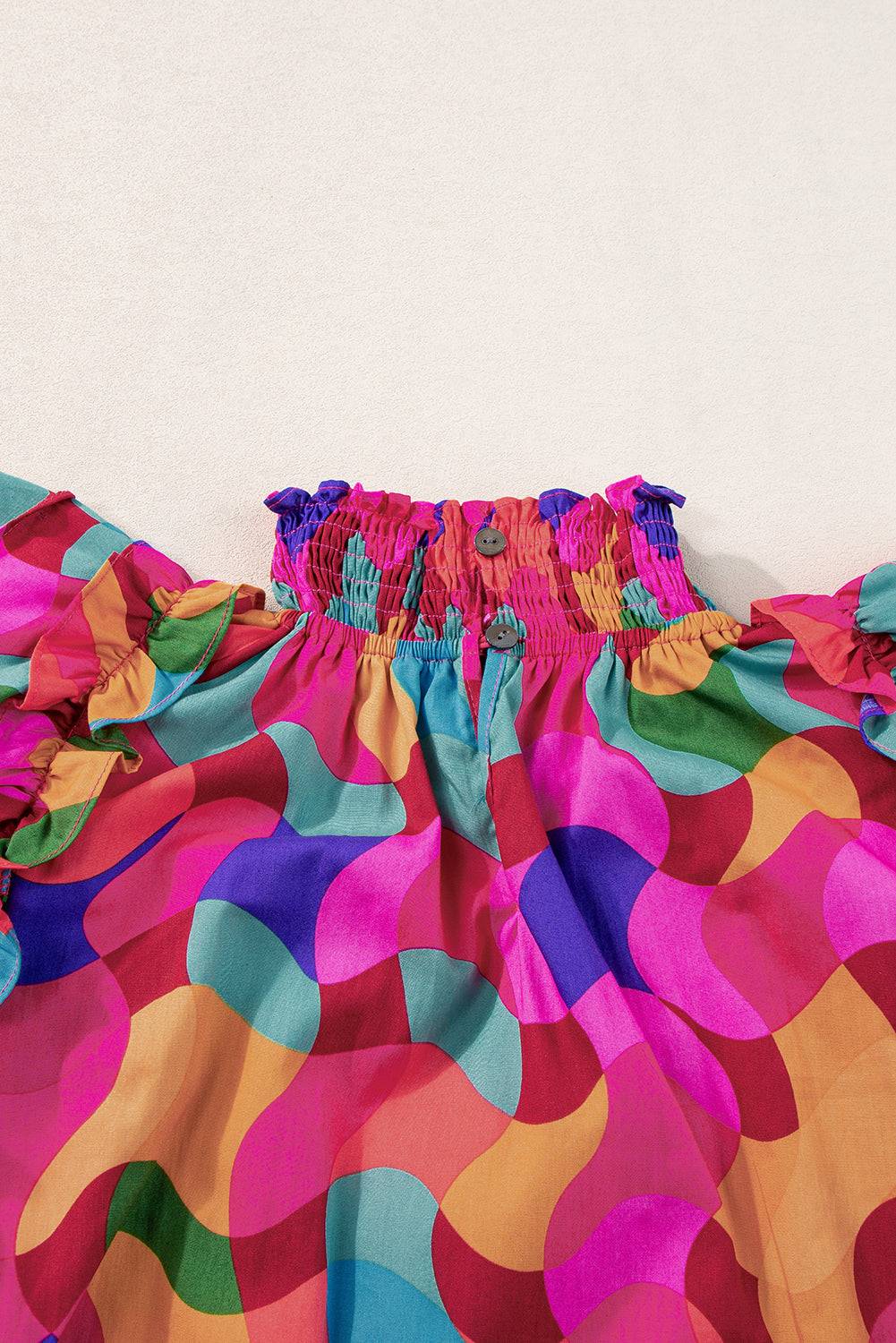 a close up of a colorful dress on a white surface