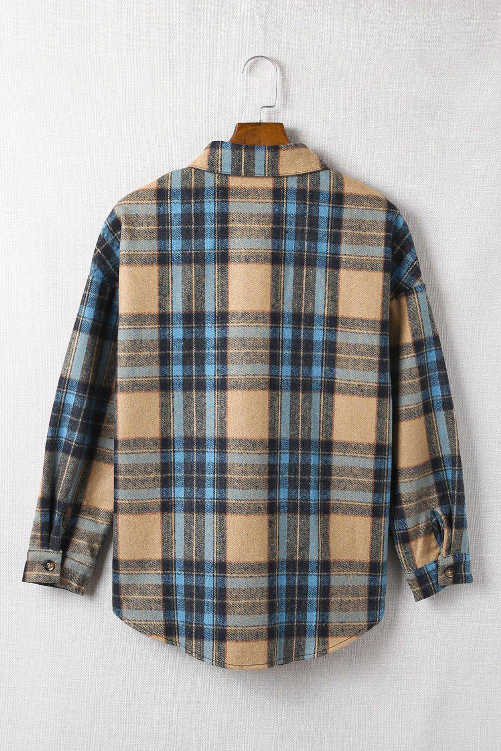 a plaid shirt hanging on a clothes hanger