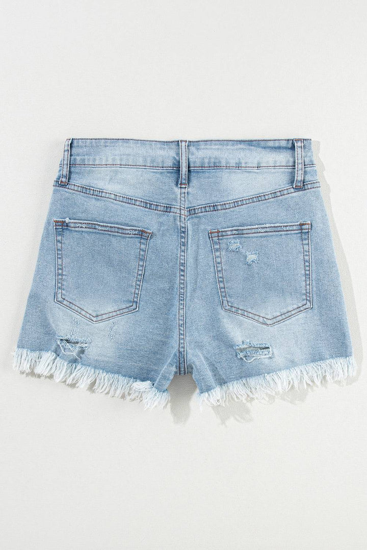 a pair of light blue jean shorts with frays