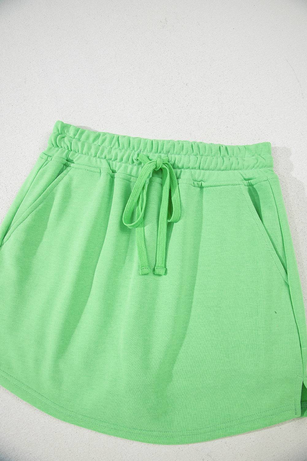 Close-up flat lay of light green French Terry mini skort with drawstring and pockets, ideal for casual comfort from Faith & Co. Boutique.