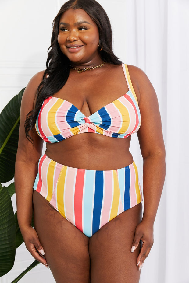 a woman in a multicolored bikini top and bottom