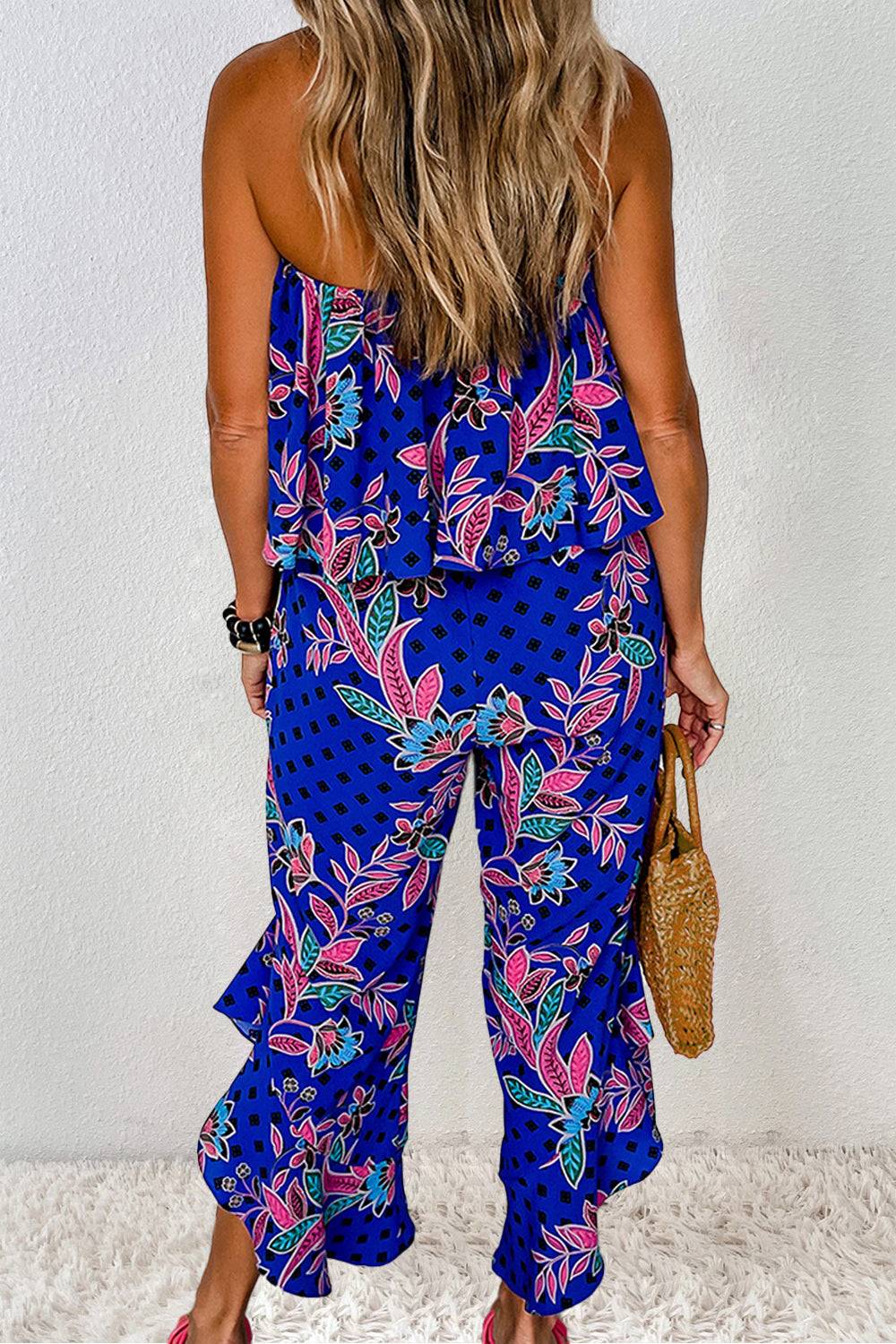 a woman wearing a blue floral print jumpsuit